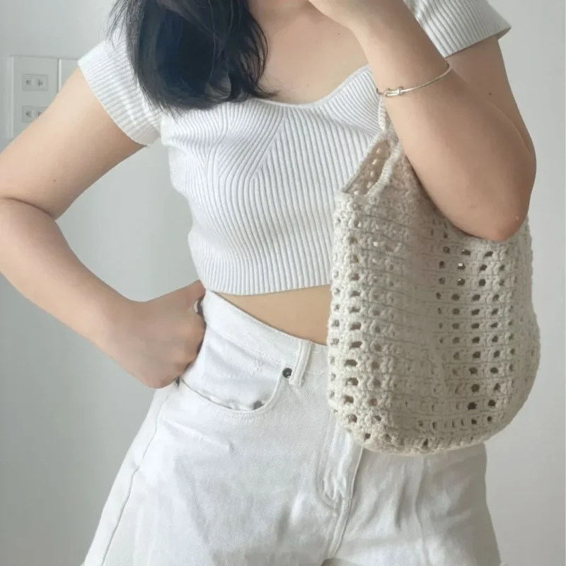 Woman wearing a handmade crochet bag - Stylish and eco-friendly fashion accessory